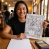A person colouring a printed page from the Tutankhamun coloring book