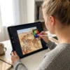 A person colouring the The Christmas Nativity Story coloring book on an iPad