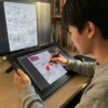 A person colouring the The Civil War coloring book on an iPad